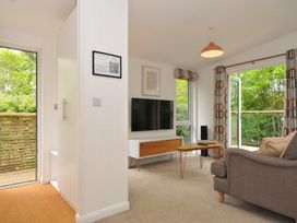A living room with a television and sofa at The Hideout in Lanreath