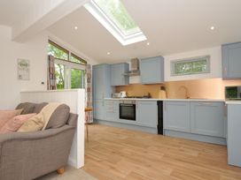 A kitchen with cabinets and a stove at The Hideout in Lanreath