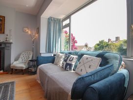 A living room with a sofa and cushions at Anchor Cottage in Salcombe