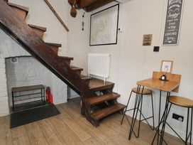 A staircase and a table with stools at Pengeulan in Cemmaes