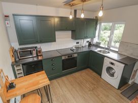 A kitchen with appliances and a counter at Pengeulan in Cemmaes