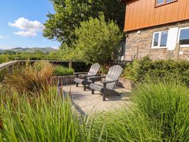 An outdoor seating area with chairs and plants at Pengeulan in Cemmaes