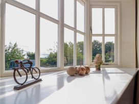 A window with decorative items on a table at Weavers Cottage in Carlton-in-Cleveland near Stokesley