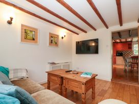 A living room with a sofa and TV at Weavers Cottage in Carlton-in-Cleveland near Stokesley