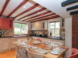 A kitchen with a dining table and chairs at Weavers Cottage Carlton-in-Cleveland near Stokesley