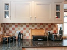 A kitchen countertop with a kettle, toaster, and canisters at Weavers Cottage Carlton-in-Cleveland near Stokesley