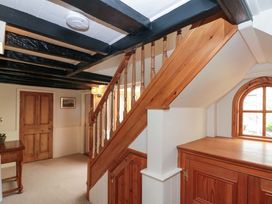 A hallway with stairs and a door at Weavers Cottage in Carlton-in-Cleveland near Stokesley