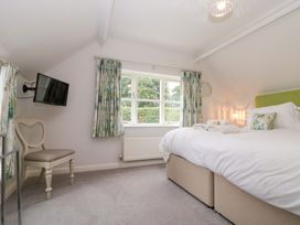A bedroom with a bed and a television at Weavers Cottage Carlton-in-Cleveland near Stokesley