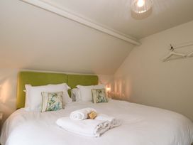 A bedroom with a bed and pillows at Weavers Cottage Carlton-in-Cleveland near Stokesley