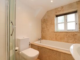 A bathroom featuring a shower, toilet, bathtub, and sink at Weavers Cottage in Carlton-in-Cleveland near Stokesley