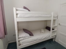 A bedroom with a bunk bed at Cwtch Ar Y Mor Burry Port