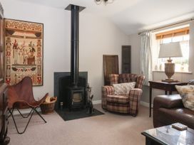 A living room with a wood-burning stove and decorative wall art at 1 Church Barns Pocklington