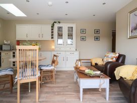 A kitchen with dining furniture and a couch at 1 Church Barns Pocklington