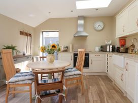 A kitchen with a table and chairs at 1 Church Barns Pocklington