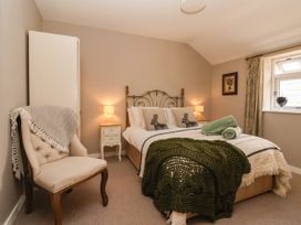 A bedroom with a bed and chair at 1 Church Barns Pocklington