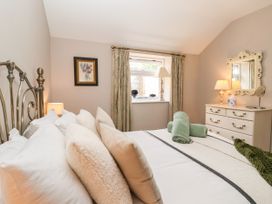 A bedroom with a bed and window at 1 Church Barns in Pocklington