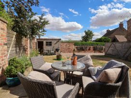 An outdoor garden featuring a table and chairs at 1 Church Barns Pocklington