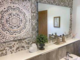 A bathroom with wall decor and sink at Larchwood Lodge in Ellon