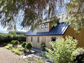 A house with a garden and pathway at Larchwood Lodge in Ellon