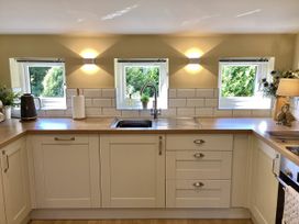 A kitchen with a sink and cabinets at Larchwood Lodge in Ellon