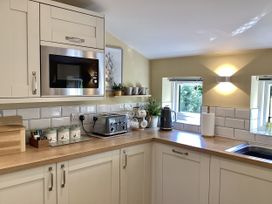 A kitchen with a microwave, kettle, and toaster at Larchwood Lodge in Ellon