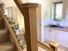 A kitchen with a sink and storage at Larchwood Lodge in Ellon