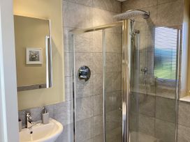 A bathroom with a shower and sink at Larchwood Lodge in Ellon