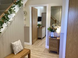 A hallway with a staircase and furniture at Larchwood Lodge in Ellon