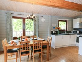 A kitchen with a dining table and chairs at Sunny View in Rhayader