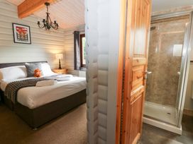 A bedroom with a bed and an adjoining shower at Sunny View in Rhayader