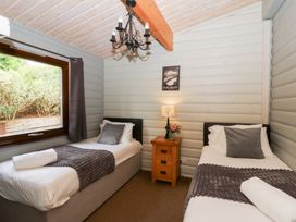 A bedroom with two single beds and a window at Sunny View Rhayader