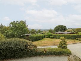 An outdoor area with houses, trees, and a pathway at Sunny View in Rhayader