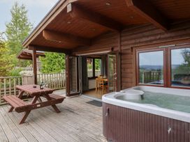 An outdoor area with a hot tub and seating at Sunny View in Rhayader