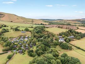 An aerial view of cabins and a house at Snowy Owl Lodge in Rhayader