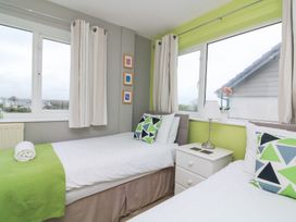 A bedroom with two beds and a window at Lanapoule Salcombe