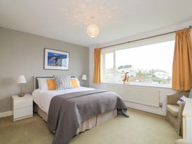 A bedroom with a bed and window at Lanapoule in Salcombe