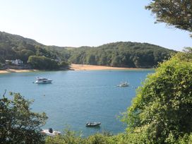 A view of boats on water with trees in the background at Lanapoule Salcombe