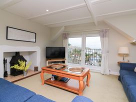 A living room with a television and coffee table at Lanapoule in Salcombe