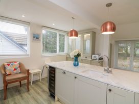 A kitchen with countertop, sink, and cabinets at Lanapoule in Salcombe