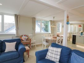 A living room with sofas and a dining area at Lanapoule in Salcombe