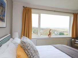 A bedroom with a bed and window view at Lanapoule Salcombe