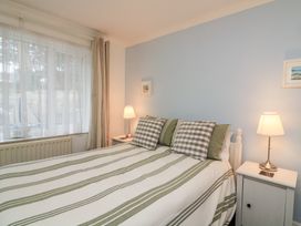 A bedroom with a bed and lamps at Lanapoule Salcombe