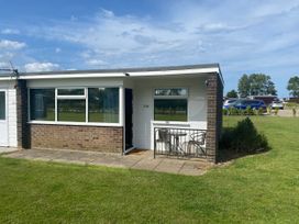 An outdoor view of a building with a patio at 246 California Road in California, Norfolk