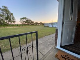 A view of a lawn and trees from an entrance at 246 California Road, California, Norfolk