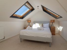 A bedroom with a bed and bedside lamps at Auverne Poundstock near Widemouth Bay