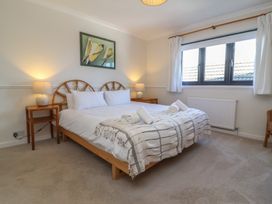 A bedroom with a bed and bedside tables at Auverne Poundstock near Widemouth Bay