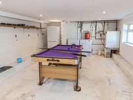 A game room with a pool table and washing machines at Auverne Poundstock near Widemouth Bay
