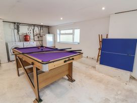A game room with a pool table and washing machine at Auverne Poundstock near Widemouth Bay