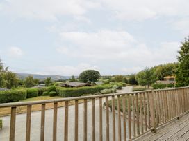 A view from a wooden deck overlooking a garden at Mountain View in Rhayader