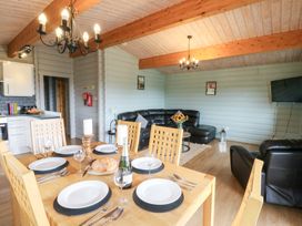 A dining area with a table set for a meal at Mountain View in Rhayader